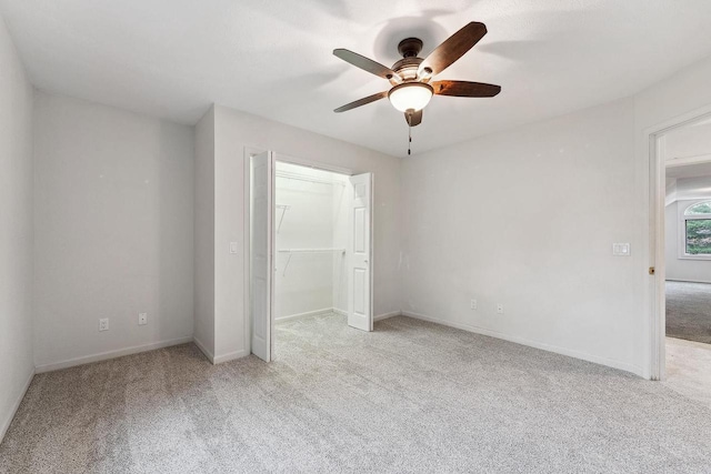 unfurnished bedroom featuring light colored carpet, ceiling fan, and a closet