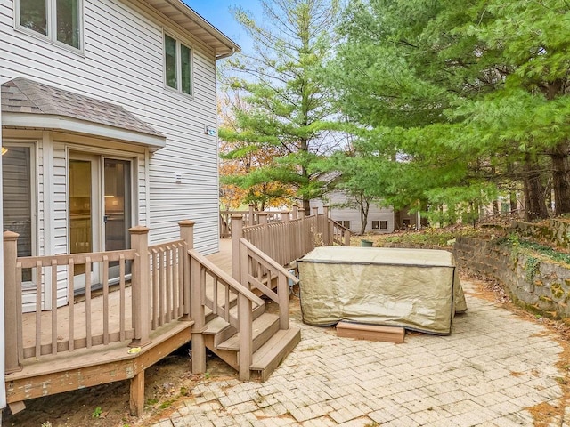 view of patio with a jacuzzi and a deck