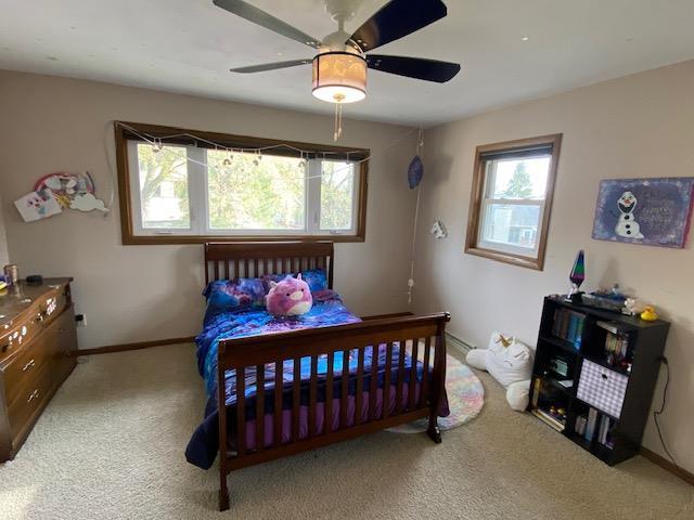 carpeted bedroom with ceiling fan