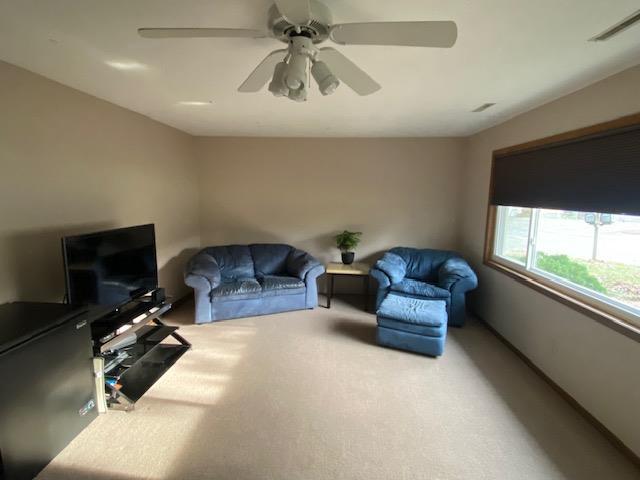 living room featuring ceiling fan and carpet floors