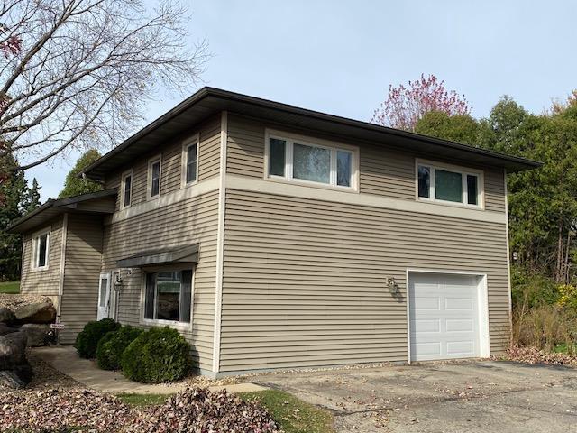 view of side of home featuring a garage