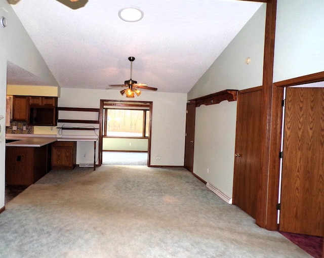 701 S Adams St, Thorp, WI 54771 - unfurnished living room with ceiling fan, vaulted ceiling, light carpet, and baseboards