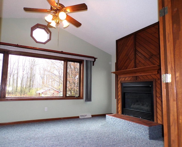 701 S Adams St, Thorp, WI 54771 - unfurnished living room featuring carpet, ceiling fan, plenty of natural light, a large fireplace, and vaulted ceiling
