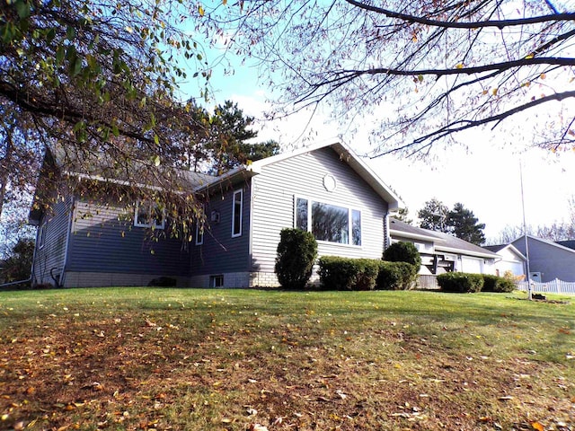 view of side of property featuring a lawn