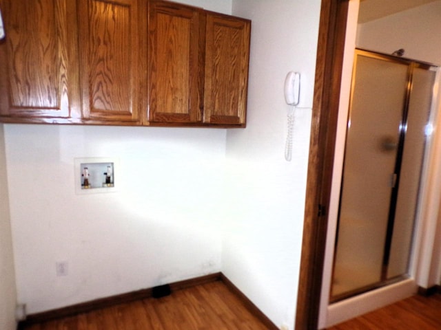 701 S Adams St, Thorp, WI 54771 - laundry room with hookup for a washing machine, cabinet space, wood finished floors, and baseboards
