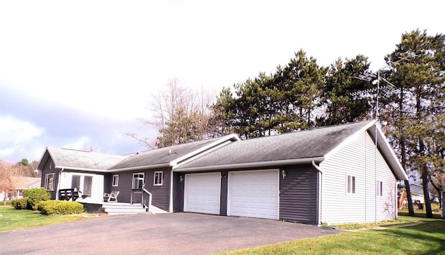 701 S Adams St, Thorp, WI 54771 - single story home with a garage, asphalt driveway, a front yard, and a shingled roof