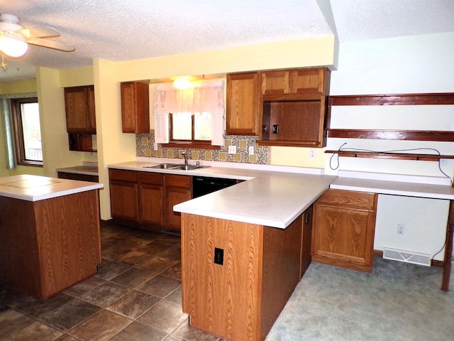 701 S Adams St, Thorp, WI 54771 - kitchen with a peninsula, brown cabinets, a sink, a textured ceiling, and ceiling fan