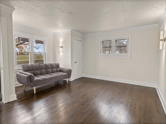 sitting room with a textured ceiling, dark hardwood / wood-style floors, and crown molding