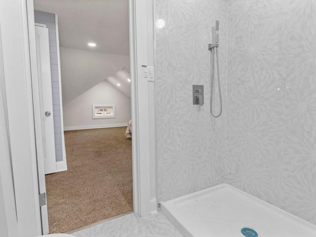 bathroom featuring a shower and vaulted ceiling