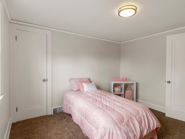 bedroom with dark colored carpet