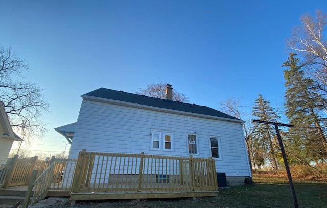 rear view of house featuring central air condition unit and a wooden deck