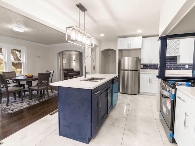 kitchen featuring sink, stainless steel appliances, decorative light fixtures, decorative backsplash, and white cabinets