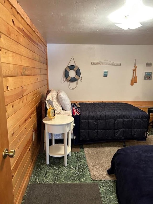 bedroom featuring wood walls