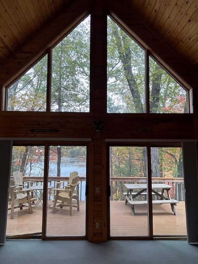 doorway featuring beamed ceiling, a water view, high vaulted ceiling, and wood ceiling