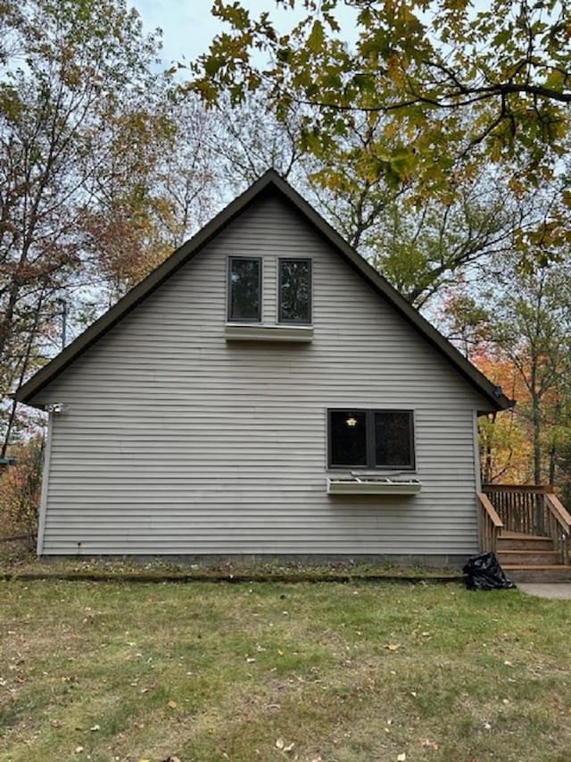 view of side of home with a yard