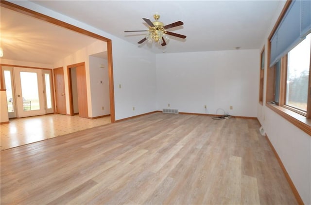 unfurnished living room featuring ceiling fan and light wood-type flooring