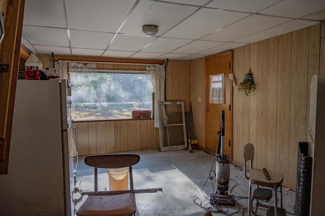 miscellaneous room with wood walls and a drop ceiling