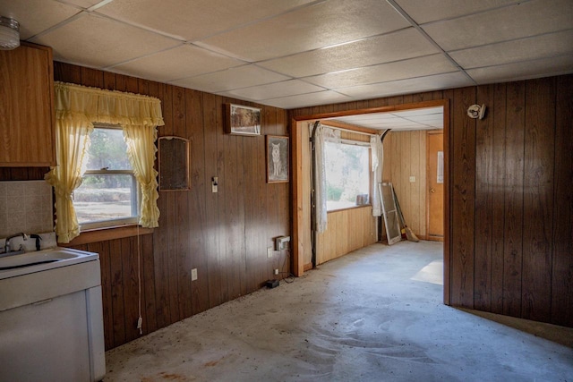 interior space featuring wood walls, a paneled ceiling, sink, and plenty of natural light