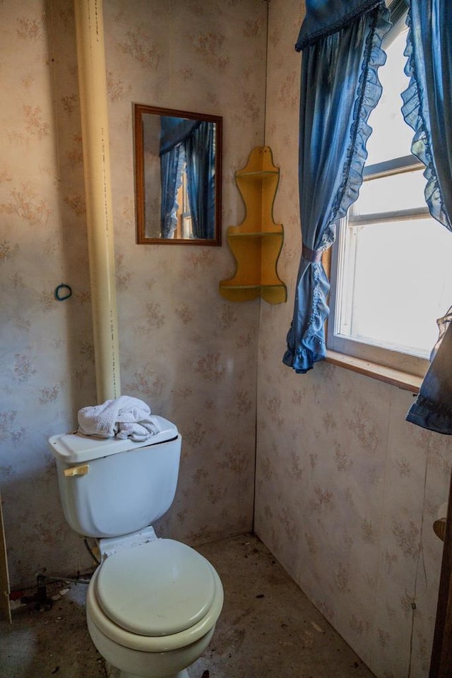 bathroom featuring toilet and a healthy amount of sunlight