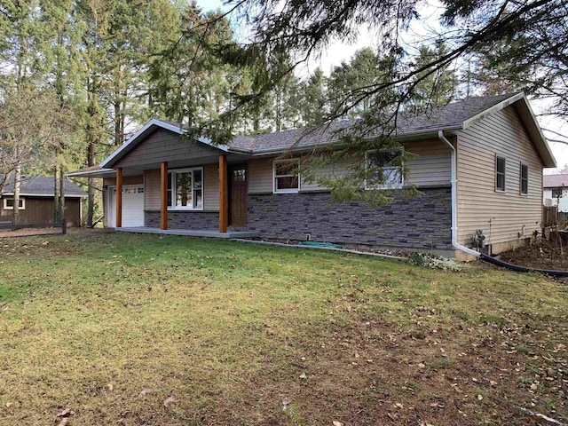 back of house with a garage and a yard