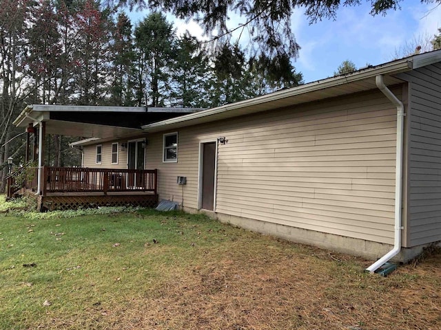 view of home's exterior with a lawn and a wooden deck