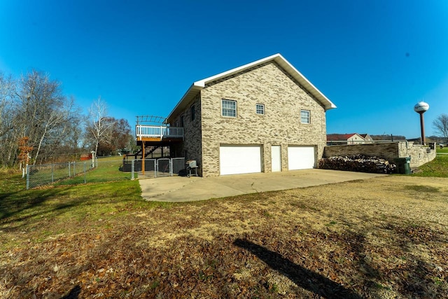 view of property exterior with a garage and a yard