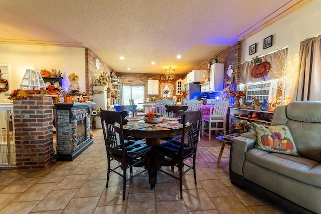 dining area with a textured ceiling, brick wall, and crown molding