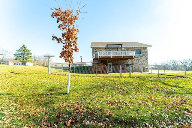 back of house featuring a lawn and a deck