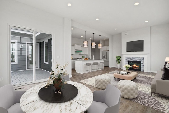 1432 Tenny Ave Unit 201, Waukesha, WI 53189 - living room featuring wood finished floors, recessed lighting, a fireplace, and baseboards