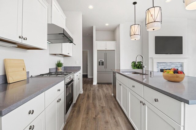 kitchen featuring white cabinets, dark wood-type flooring, sink, and a kitchen island with sink