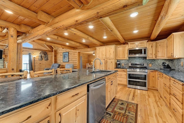 E7498 Mill Rd, Spring Green, WI 53588 - kitchen with stainless steel appliances, log walls, light wood finished floors, a wood ceiling with exposed beams, and light brown cabinetry