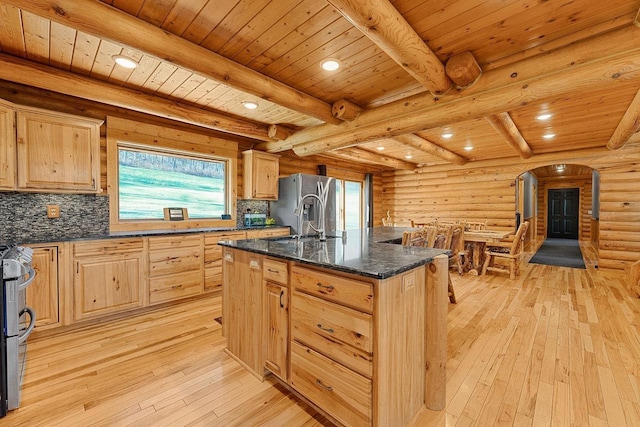 E7498 Mill Rd, Spring Green, WI 53588 - kitchen with light wood-style flooring, arched walkways, light brown cabinetry, tasteful backsplash, and recessed lighting