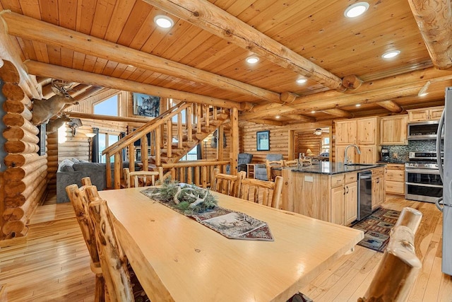 E7498 Mill Rd, Spring Green, WI 53588 - dining area with rustic walls, light wood-style flooring, recessed lighting, and a wooden ceiling with exposed beams