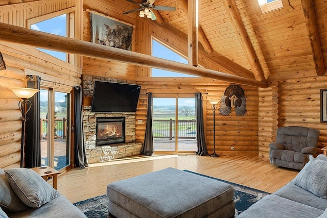 E7498 Mill Rd, Spring Green, WI 53588 - living area with wood finished floors, a wooden ceiling with exposed beams, a stone fireplace, high vaulted ceiling, and ceiling fan