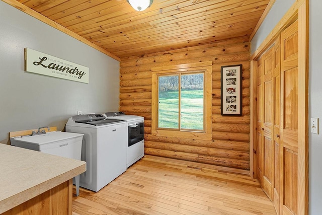 E7498 Mill Rd, Spring Green, WI 53588 - laundry room with separate washer and dryer, rustic walls, wooden ceiling, and light wood-type flooring