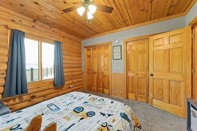 E7498 Mill Rd, Spring Green, WI 53588 - bedroom with log walls, carpet floors, multiple closets, wainscoting, and wood ceiling