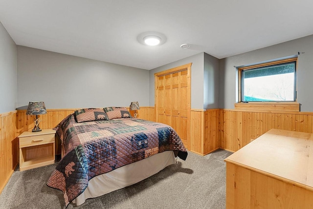 E7498 Mill Rd, Spring Green, WI 53588 - carpeted bedroom featuring a wainscoted wall, wood walls, and a closet