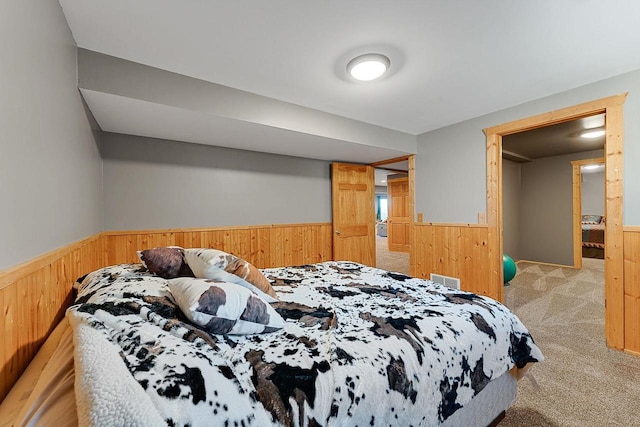 E7498 Mill Rd, Spring Green, WI 53588 - bedroom featuring wainscoting, wood walls, and light colored carpet