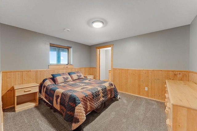 E7498 Mill Rd, Spring Green, WI 53588 - bedroom with wainscoting, carpet flooring, and wood walls