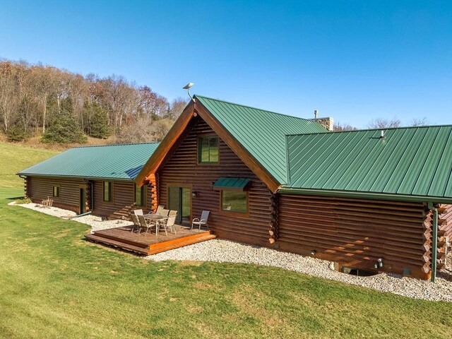 E7498 Mill Rd, Spring Green, WI 53588 - rear view of property featuring log exterior, a chimney, and a yard