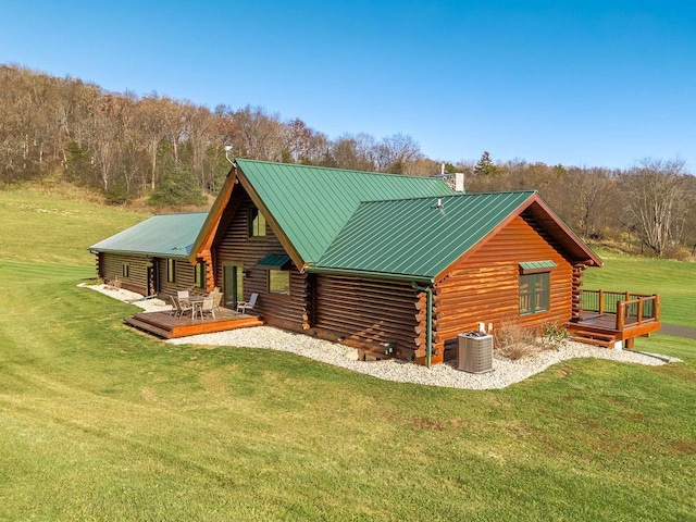 E7498 Mill Rd, Spring Green, WI 53588 - rear view of house featuring log exterior, a wooden deck, a yard, a chimney, and a metal roof