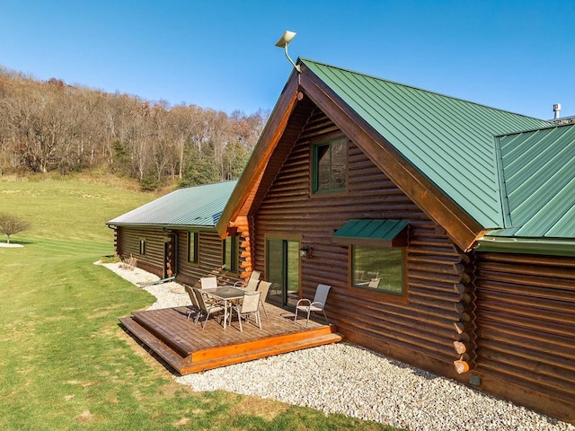 E7498 Mill Rd, Spring Green, WI 53588 - rear view of house featuring log exterior, a metal roof, a wooden deck, and a yard