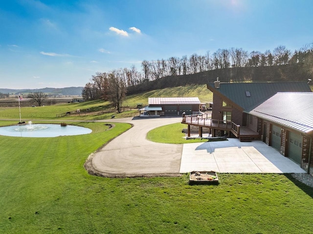 E7498 Mill Rd, Spring Green, WI 53588 - surrounding community featuring concrete driveway, a yard, a wooden deck, and a garage