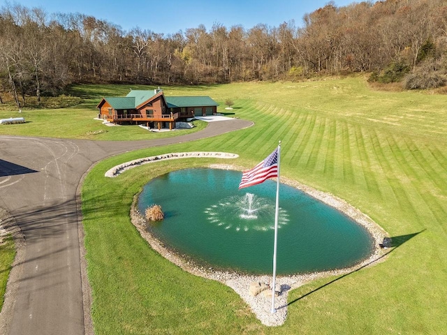 E7498 Mill Rd, Spring Green, WI 53588 - surrounding community with a water view, a lawn, a garage, and a forest view