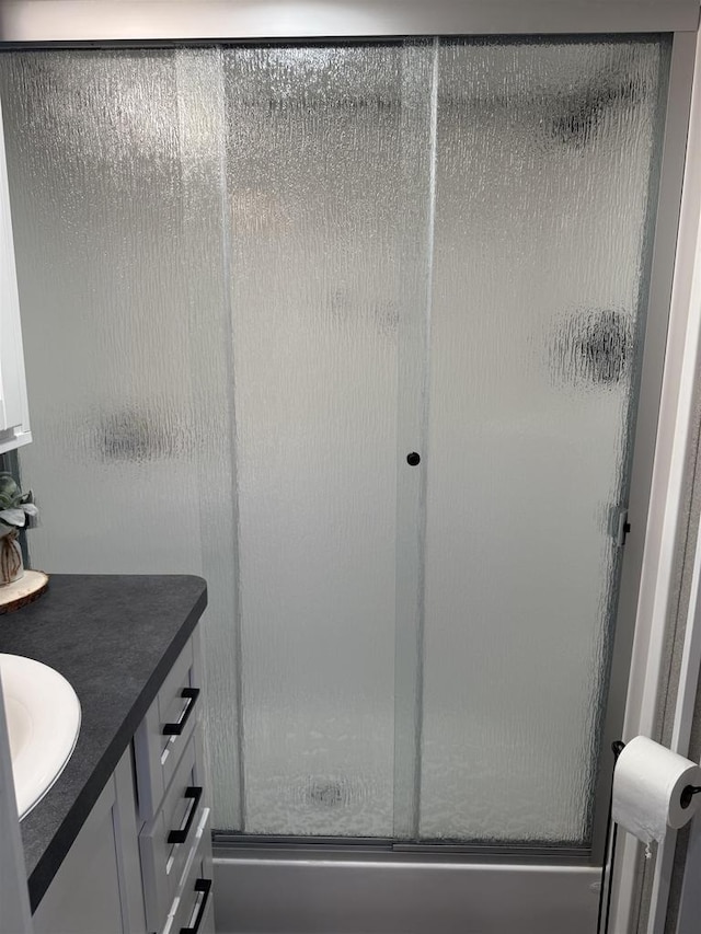 bathroom featuring an enclosed shower and vanity