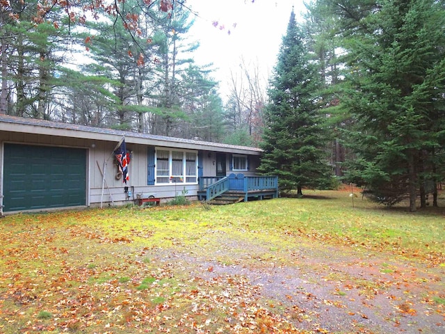 ranch-style house featuring a garage and a front yard