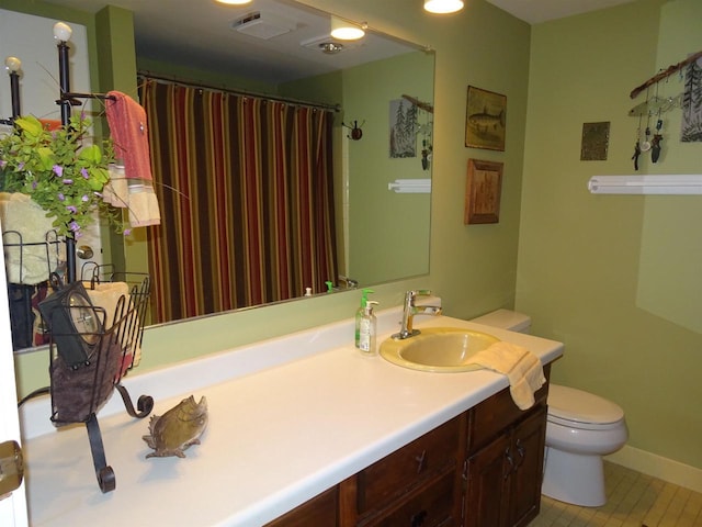 9675 Wayne Dr, Woodruff, WI 54568 - full bath with toilet, tile patterned floors, vanity, baseboards, and a shower with curtain