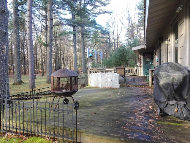 9675 Wayne Dr, Woodruff, WI 54568 - wooden deck featuring outdoor dining area, a gazebo, view of wooded area, and fence