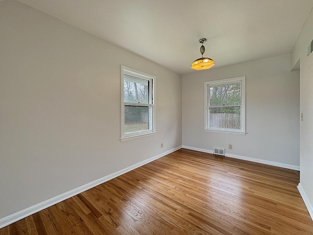 spare room with hardwood / wood-style flooring