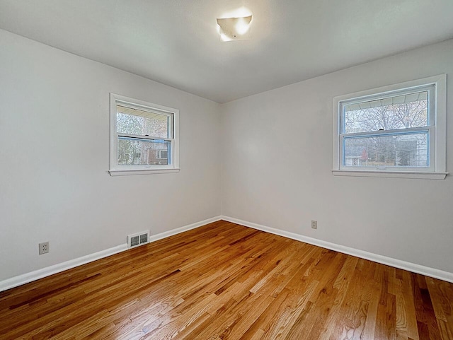 empty room featuring light hardwood / wood-style floors and a healthy amount of sunlight